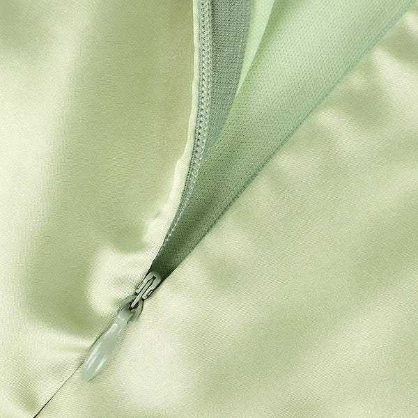 detail of green bodycon satin dress